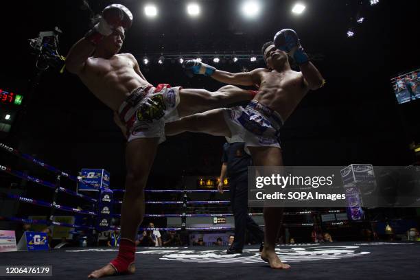 Boxers in action during the Thai Boxing match that was held without spectators as a preventive measure against the spread of COVID-19 coronavirus at...