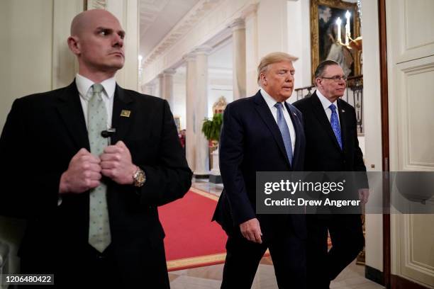 Secret Service agents stands as U.S. President Donald Trump and retired four-star Army general Jack Keane arrive for a ceremony to present the...