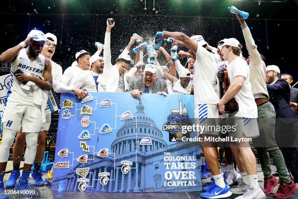 The Hofstra Pride celebrate winning the CAA Men's Basketball Tournament - Championship college basketball game against the Northeastern Huskies at...