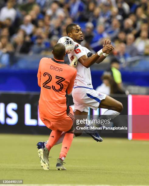 Goalkeeper Clement Diop of the Montreal Impact competes for the ball with Jerry Bengtson of CD Olimpia in the first half during the 1st leg of the...