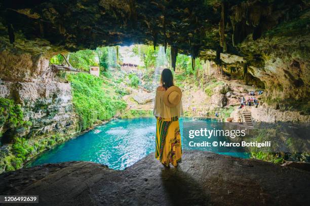 woman admiring a cenote in yucatan peninsula, mexico - cenote mexico stock pictures, royalty-free photos & images