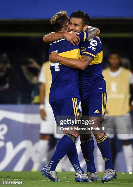 Eduardo Salvio of Boca Juniors celebrates with teammate Julio Buffarini after scoring the second goal of his team during a Group H match between Boca...