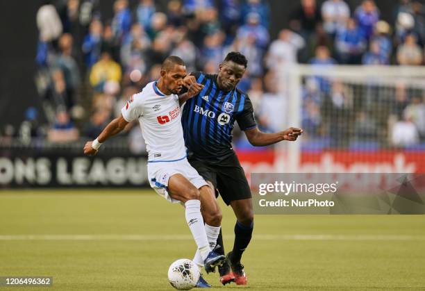 Jerry Bengtson of CD Olimpia and Victor Wanyama of Montreal Impact challenging for the ball during the CONCACAF Champions League quarterfinal match...