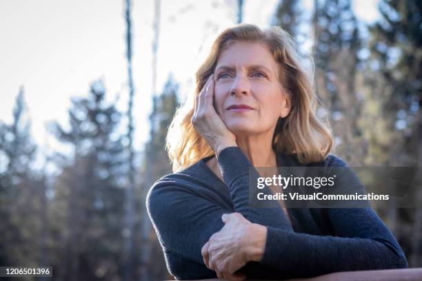 portrait of senior woman outdoors. - introspection stock pictures, royalty-free photos & images