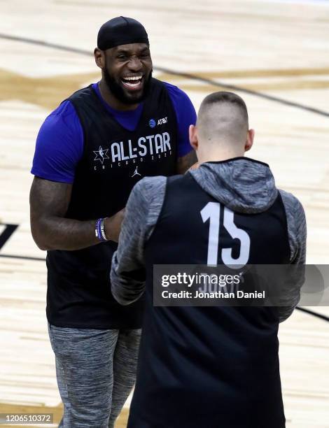 LeBron James of the Los Angeles Lakers meets with Nikola Jokic of the Denver Nuggets during 2020 NBA All-Star - Practice & Media Day at Wintrust...