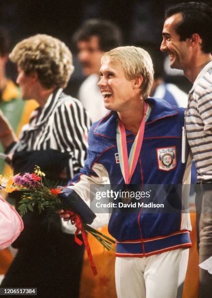 Bart Conner ( of the United States celebrates after an awards ceremony during the Men's Gymnastics competition of the 1984 Summer Olympic Games held...