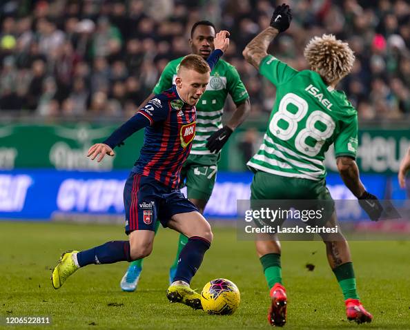 Ivan Petryak of MOL Fehervar FC dribbles between Franck Boli of