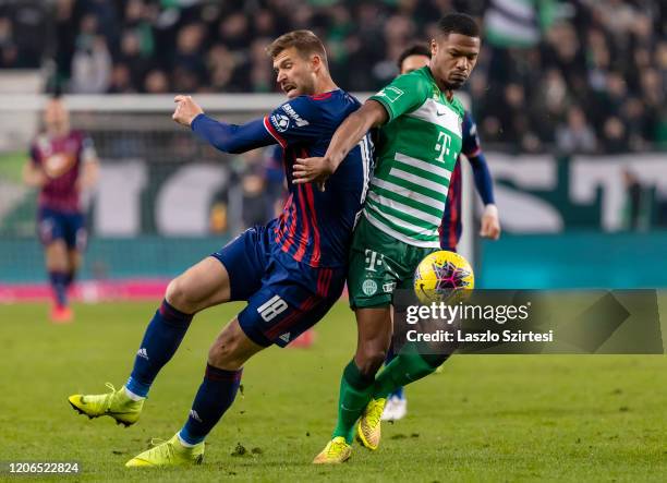 Kenneth Otigba of Ferencvarosi TC tackles Marko Futacs of MOL