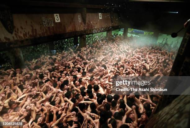 Approximately 10,000 men in loincloths try to snatch a lucky wooden stick during the 'Eyo' naked festival at Saidaiji Temple on February 15, 2020 in...