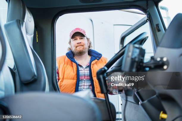 trucker driver climbing into his semi-truck - toughness stock pictures, royalty-free photos & images