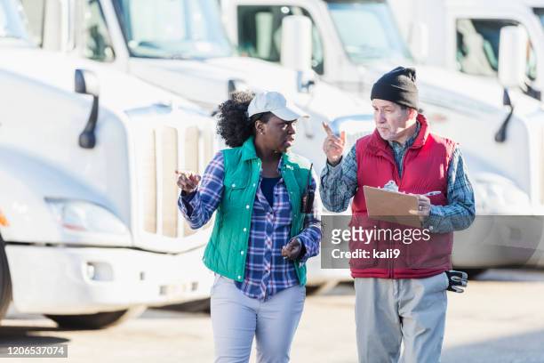 truck drivers with fleet of semi-trucks - fleet manager stock pictures, royalty-free photos & images