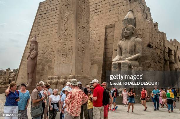 Tourists visit the Luxor Temple in Egypt's southern city of Luxor, on March 11, 2020. - Egyptian authorities said that 46 French and US tourists who...