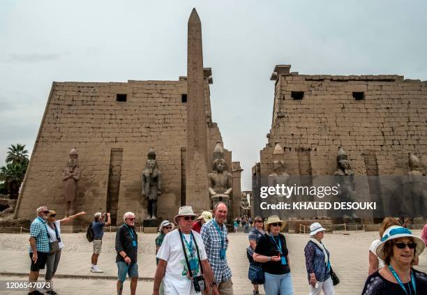 Tourists visit the Luxor Temple in Egypt's southern city of Luxor, on March 11, 2020. - Egyptian authorities said that 46 French and US tourists who...