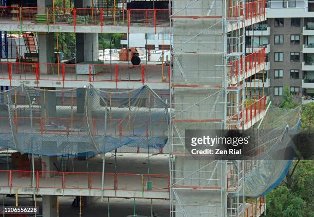 building under construction with safety nettings and scaffoldings - safety net stock pictures, royalty-free photos & images