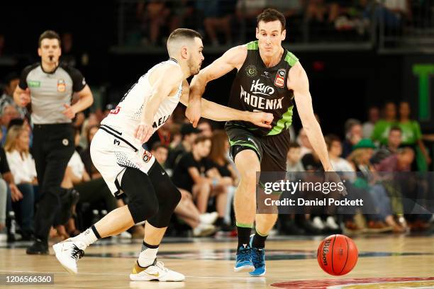 Ben Madgen of the Phoenixruns with the ball under pressure from Chris Goulding of United during the round 20 NBL match between South East Melbourne...