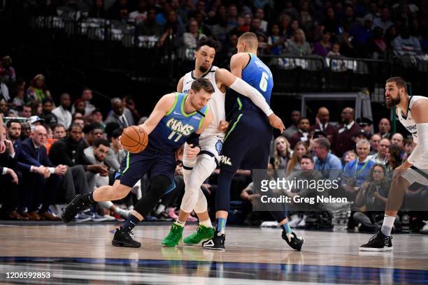 Dallas Mavericks Luka Doncic in action vs Memphis Grizzlies Tyus Jones vs at American Airlines Center. Porzingis setting pick. Dallas, TX 3/6/2020...