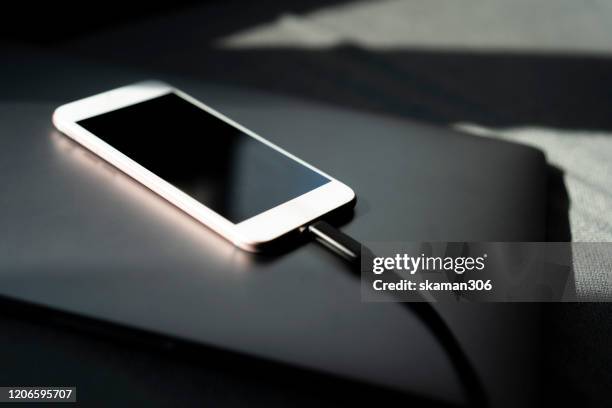 close up focus cellphone charging and connecting with charger and copy space - charging cable stock pictures, royalty-free photos & images