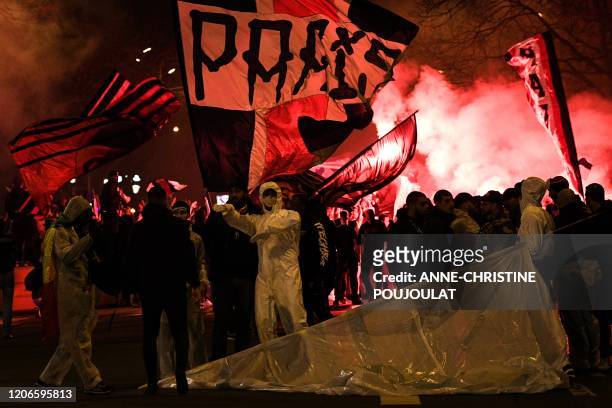 Supporters wave flags and chant slogans outside the Parc des Princes stadium ahead of the UEFA Champions League round of 16 second leg football match...