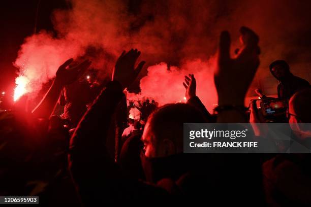 Supporters wave smoke flares and chant slogans outside the Parc des Princes stadium ahead of the UEFA Champions League round of 16 second leg...