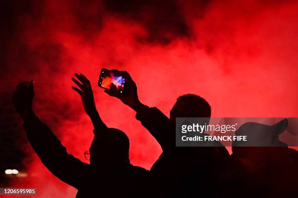 Supporters chant slogans outside the Parc des Princes stadium during of the UEFA Champions League round of 16 second leg football match between Paris...