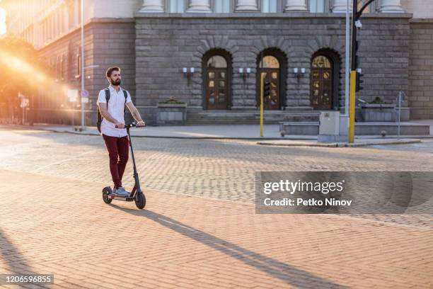 going to work with the e-scooter - man on scooter stock pictures, royalty-free photos & images