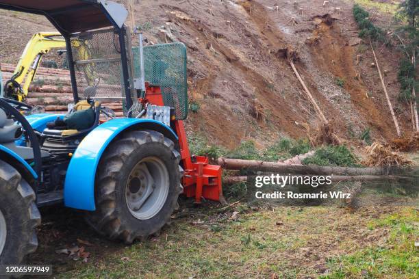 tractor clearing fallen trees after storm - mudslides photos et images de collection