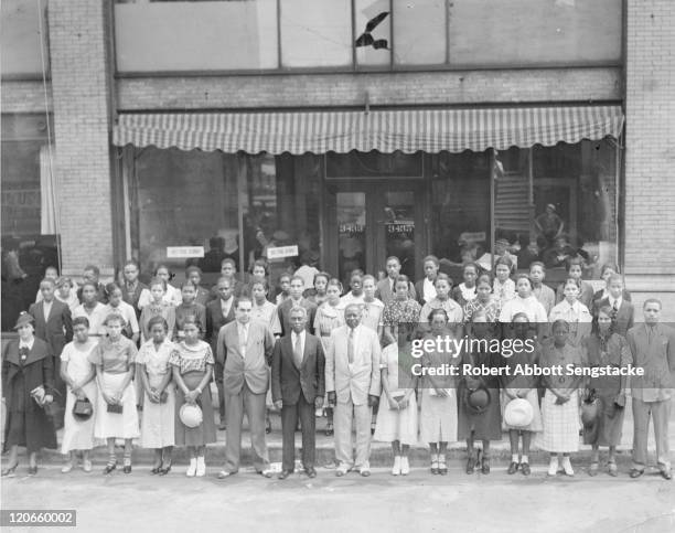 American newspaper publisher Robert Sengstacke Abbott poses with honor students and faculty from Atlanta's Booker T. Washington High School, 1936.