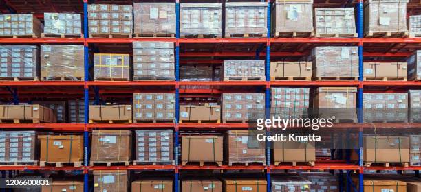 cardboard boxes on shelves in warehouse. - retail shelves stock pictures, royalty-free photos & images