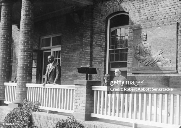 American newspaper publisher Robert Sengstacke Abbott delivers a speech from the porch of an unspecified building on the campus of the Hampton...