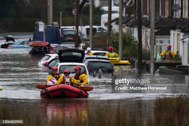 Woman is rescued from a property on Oxford Street on February 16, 2020 in Nantgarw, Wales.The Met Office have issued a red weather warning for rain...