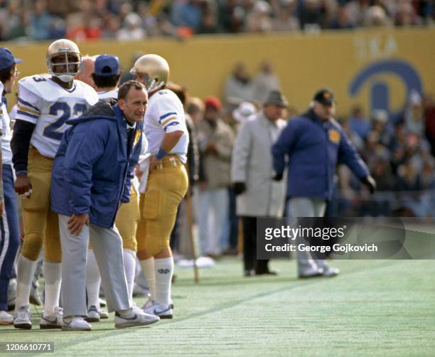 Head coach Gerry Faust of the University of Notre Dame Fighting Irish looks on from the sideline while standing near safety Dave Duerson during a...