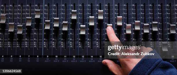 amplifying equipment that adjusts studio audio mixer knobs and faders. workplace and equipment of the sound engineer. acoustic mixing of music, selective focus. banner. - dj mixing table stock pictures, royalty-free photos & images