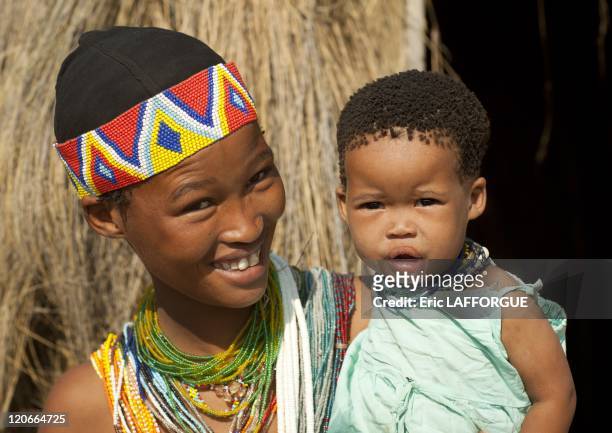 San Woman With Her Baby in Namibia on August 22, 2010 - San are an ethnic group of South West Africa. They live in the Kalahari Desert across the...