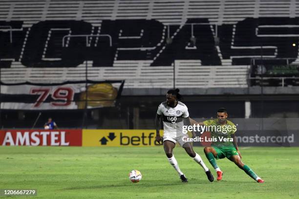 Sheyi Adebayor of Olimpia and Hector Martinez of Defensa y Justicia fight for the ball during a match between Olimpia and Defensa y Justicia as part...