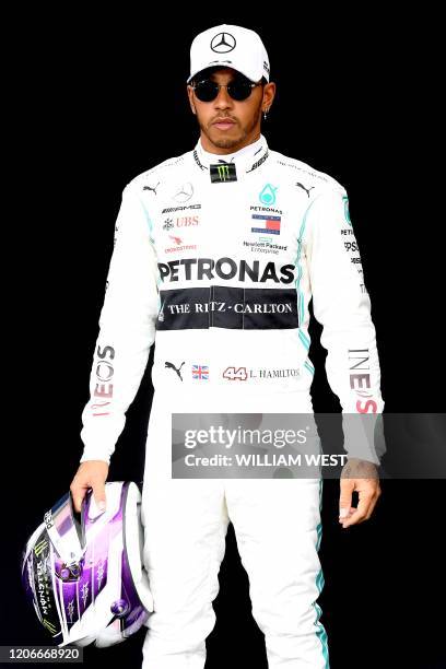 Mercedes' British driver Lewis Hamilton poses for a photo at the Albert Park circuit ahead of the Formula One Australian Grand Prix in Melbourne on...