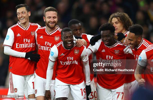 Nicolas Pepe of Arsenal celebrates after scoring his sides second goal with team mates during the Premier League match between Arsenal FC and...