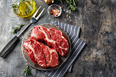 Raw beef steak on dark gray background