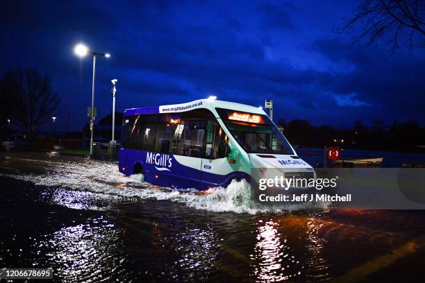 Vehicles make their way through flooding at Dumbarton Quay during storm Dennis on February 15, 2020 in Dumbarton, Scotland. Towns in the Scottish...