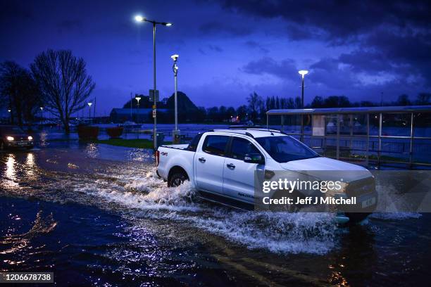 Vehicles make their way through flooding at Dumbarton Quay during storm Dennis on February 15, 2020 in Dumbarton, Scotland. Towns in the Scottish...