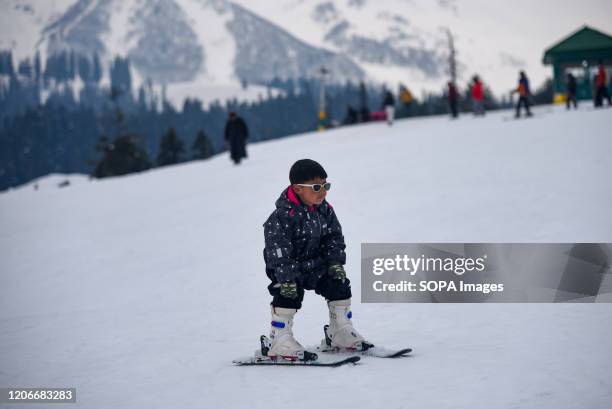 Young skier in action at the famous ski resort during a sunny day in Gulmarg. Gulmarg Resort is a big ski hill serviced by a gondola. The ski season...