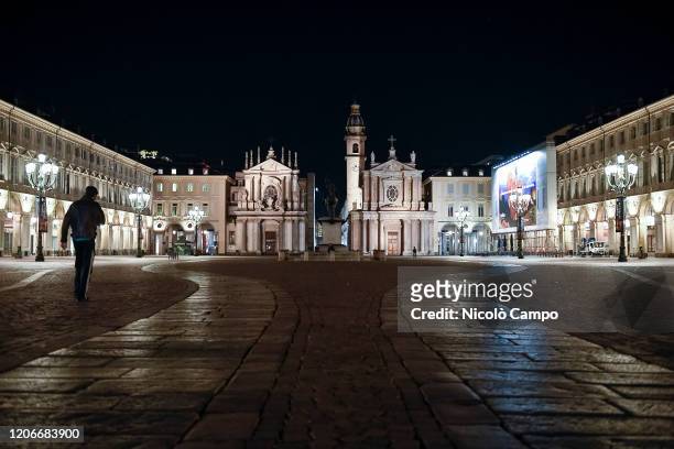 Men walks in almost deserted piazza San Carlo. The Italian government puts the whole country on lockdown as Italy is battling COVID-19 coronavirus...
