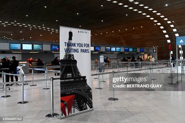 Picture taken on March 12, 2020 shows empty Delta Airlines check-in desk at Paris-Charles-de-Gaulle airport after a US 30-day ban on travel from...