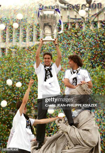 Raul Gonzalez who scores the first goal of the champions league final jubilates with the cup on the top of the statue in Cibeles square in Madrid the...