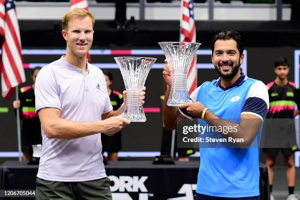 Dominic Inglot of Great Britain and Aisam-Ul-Haq Qureshi of Pakistan celebrate with their championship trophies after winning their Men's Double's...