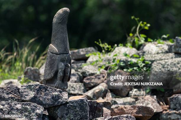Sculpture of a bird carved from soapstone was temporarily moved from a museum at the same site to be placed back in its original position at the...