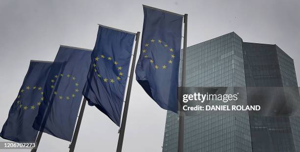 Flags of the European Union flutter in front of the headquarters of the European Central Bank in Frankfurt am Main, western Germany, on March 12,...