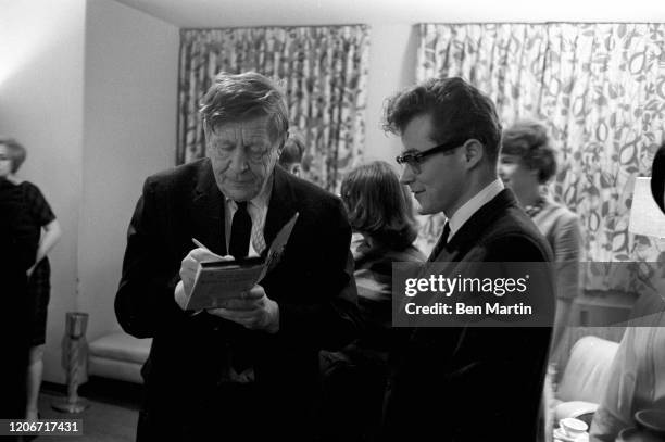 Auden , English-American poet, with students signing a book of poetry following a poetry reading at the Madison campus of the University of...