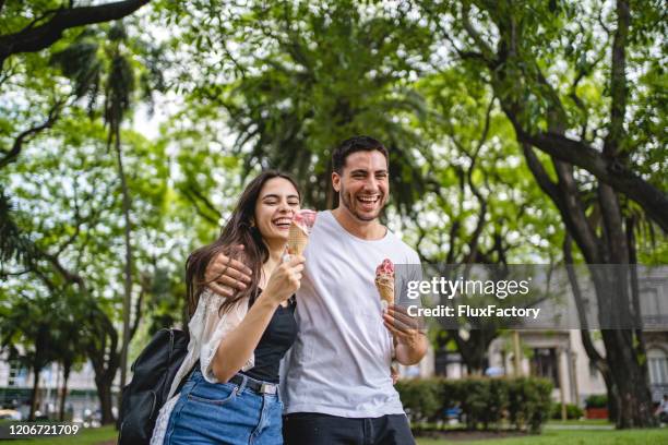 couple bonding while eating ice cream - spring romance stock pictures, royalty-free photos & images