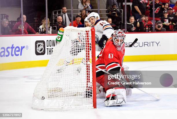 Josh Archibald of the Edmonton Oilers scores the game-winning goal against James Reimer of the Carolina Hurricanes in overtime of their game at PNC...