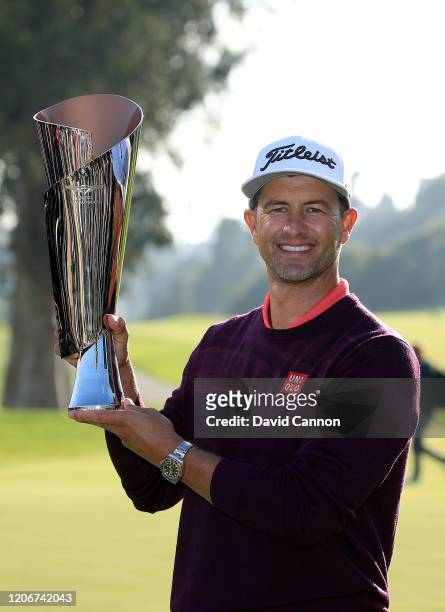 Adam Scott of Australia holds the trophy after his two shot win during the final round of the Genesis Invitational at The Riviera Country Club on...